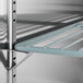 A black metal shelf with a metal bar.