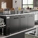 An Avantco UDD-4-HC triple tap beer dispenser on a bar counter.
