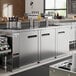 An Avantco stainless steel counter with four beer taps.