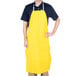 A man wearing a yellow San Jamar dishwasher apron.