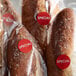 A close-up of a plastic bag of Point Plus red round special labels.