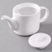 An Arcoroc white teapot with a lid.