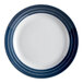 A close-up of a Libbey Lunar Bright white porcelain plate with blue stripes.