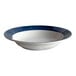 A close-up of a Libbey Lunar Bright White porcelain bowl with a steel blue rim.