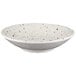 A white melamine bowl with black speckled spots.