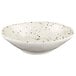 a white bowl with brown speckled spots