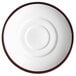 A white porcelain saucer with a brown rim.