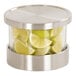 A large glass mixology jar set with stainless steel accents, filled with lime wedges.
