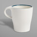 A white porcelain cup with a blue rim and handle.