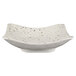 A white square melamine bowl with black speckles.