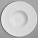 A white porcelain plate with a round center and a circular rim.