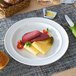 A Villeroy & Boch white porcelain plate with meat and cheese on it on a table.