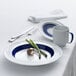 A white and dark blue Schonwald porcelain mug with a blue rim.
