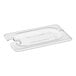 A clear plastic Cambro lid for a white food container with a spoon notch.