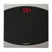 A black Taylor digital bathroom scale with red numbers.