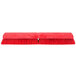 A red Carlisle Sparta Omni Sweep push broom head with long bristles.