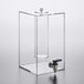 A clear plastic GET Enterprises beverage dispenser with a tap and metal handle.