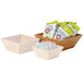 Three square bamboo bowls with liners holding candy, popcorn, and snacks.