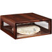 A walnut rectangular bread box on a table with a tortilla inside.