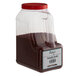 A plastic container of Regal Annatto seeds with a red lid.