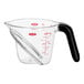 A clear plastic OXO measuring cup with a black handle.