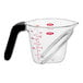 A clear plastic OXO measuring cup with a black handle.