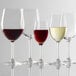 Four Stolzle Classic port wine glasses on a white surface.