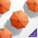 A customizable California Umbrella with a silver pole and orange Sunbrella fabric with a Tuscan pattern.