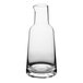 An American Metalcraft clear glass carafe with a small amount of liquid.