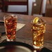 Two glasses of ice tea with lemon slices on a table.