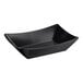 A black rectangular Tablecraft serving basket with a curved edge and a handle.