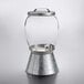 A Stylesetter glass beverage dispenser with a metal lid.