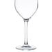 An Arcoroc clear wine glass with a stem.