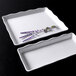 A white rectangular tray with a scalloped edge.