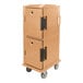 A tan plastic Cambro Ultra Camcart for food pans on wheels.