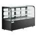 An Avantco black curved glass dry bakery display case on a counter with glass shelves.