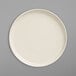 A Libbey white china pizza platter with a white rim.