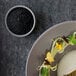 A plate of food with a stackable stone gray RAK Porcelain ramekin on it.