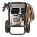 A close-up of a Simpson gas powered pressure washer with hose.