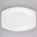 A Dart white foam platter on a gray surface.