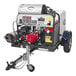 A Simpson gas powered trailer pressure washer with a red Honda engine.