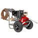 A red and black Simpson pressure washer with a hose attached and wheels.