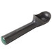 A black scoop with a green handle.