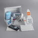 A white box with a white and orange label and a triangular design containing a variety of Purell cleaning supplies.