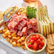 A plate with Citterio Hot Sopressata, cheese, and crackers on a table.