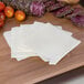 A cutting board with Land O Lakes white American cheese, tomatoes, and other food.