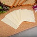 A cutting board with slices of Yancey's Fancy horseradish cheddar cheese, bread, and vegetables.