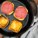 A close up of Taylor Provisions pork roll on a black surface.