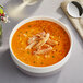 A bowl of soup with Handy Claw Crab Meat and a spoon.