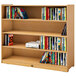 A Whitney Brothers wooden mobile three shelf cabinet with books on it.